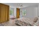 Bright bedroom featuring a decorative window, comfortable bed, and cozy seating area at 6290 Cascade Palmetto Hwy, Fairburn, GA 30213