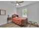 Bright bedroom with hardwood floors, a ceiling fan, and classic wooden furniture with a decorative antique headboard at 6290 Cascade Palmetto Hwy, Fairburn, GA 30213