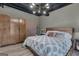 Charming bedroom with light wood floors, modern light fixture, neutral colors, and a wooden wardrobe at 6290 Cascade Palmetto Hwy, Fairburn, GA 30213