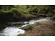 Peaceful creek flowing through the property, creating a serene natural setting at 6290 Cascade Palmetto Hwy, Fairburn, GA 30213