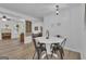 Bright dining area with a white round table, black chairs, and modern lighting at 6290 Cascade Palmetto Hwy, Fairburn, GA 30213