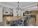 Open dining area with an expansive table, chandelier, and flows into the living room and newly remodeled kitchen at 6290 Cascade Palmetto Hwy, Fairburn, GA 30213