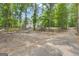 Gravel driveway leading to the property, surrounded by trees, with fenced yard and white two-story house visible at 6290 Cascade Palmetto Hwy, Fairburn, GA 30213