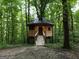 Unique treehouse home with a wooden walkway nestled in a serene, wooded environment at 6290 Cascade Palmetto Hwy, Fairburn, GA 30213