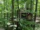 Wonderful treehouse exterior with wood siding, a wrap-around deck, and situated amongst many trees at 6290 Cascade Palmetto Hwy, Fairburn, GA 30213