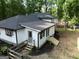 Aerial shot of home's exterior showing the recently painted white siding, black roof, and new porch steps at 6290 Cascade Palmetto Hwy, Fairburn, GA 30213