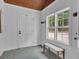 Bright and airy foyer featuring bench seating, tile flooring, and large windows that flood the space with natural light at 6290 Cascade Palmetto Hwy, Fairburn, GA 30213