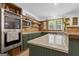 Kitchen with stainless appliances, gas cooktop island, wooden backsplash, and modern countertops at 6290 Cascade Palmetto Hwy, Fairburn, GA 30213