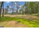 Sprawling land with short grassy patches and scattered trees under a beautiful blue sky at 6290 Cascade Palmetto Hwy, Fairburn, GA 30213
