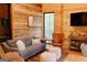 Comfortable living room with wood walls, a sofa, and natural light at 6290 Cascade Palmetto Hwy, Fairburn, GA 30213
