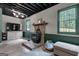 Spacious living room boasts wood flooring, a stone fireplace, and bright windows at 6290 Cascade Palmetto Hwy, Fairburn, GA 30213