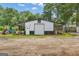 Spacious outbuilding on a beautiful lot featuring roll up door and covered overhang for storage and hobbies at 6290 Cascade Palmetto Hwy, Fairburn, GA 30213