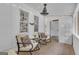 Cozy screened porch featuring rocking chairs, ceiling fan, and views to the lush backyard, ideal for relaxation at 6290 Cascade Palmetto Hwy, Fairburn, GA 30213