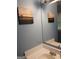 Bathroom vanity area with neutral paint, mirror, and framed wall art at 920 Courthouse Rd, Temple, GA 30179