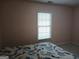 Bedroom featuring a bed with white comforter and blue and orange floral design at 920 Courthouse Rd, Temple, GA 30179