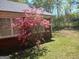 View of a pink azalea bush against the brick wall of the home at 920 Courthouse Rd, Temple, GA 30179