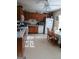 Bright kitchen with wooden cabinets, white appliances, and adjacent dining area at 920 Courthouse Rd, Temple, GA 30179