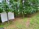 Shed in the back yard surrounded by trees and lush green foliage at 920 Courthouse Rd, Temple, GA 30179