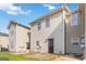 The home's backyard features vinyl siding, a small patio, and lawn at 2268 Nicole Dr, Hampton, GA 30228