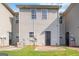 The backyard has a small patio area, vinyl siding, and an exterior door to the home at 2268 Nicole Dr, Hampton, GA 30228