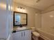 This bathroom has a bath/shower combo, single sink vanity, and neutral paint at 2268 Nicole Dr, Hampton, GA 30228