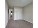 Comfortable bedroom featuring neutral carpeting and a spacious closet with double doors at 2268 Nicole Dr, Hampton, GA 30228