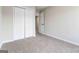 Bedroom showcasing a closet and entrance, complete with neutral walls and plush carpeting at 2268 Nicole Dr, Hampton, GA 30228