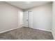 This bedroom features neutral walls, plush carpet, and a closet for ample storage space at 2268 Nicole Dr, Hampton, GA 30228