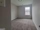 Cozy bedroom with neutral carpeting and a window offering natural light at 2268 Nicole Dr, Hampton, GA 30228
