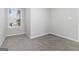 A neutral bedroom featuring a window with exterior views and gray carpet at 2268 Nicole Dr, Hampton, GA 30228