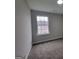 This bedroom has neutral paint, carpet, a large window and nice natural light at 2268 Nicole Dr, Hampton, GA 30228