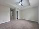 This bedroom has neutral paint, carpet, and a modern ceiling fan and closet at 2268 Nicole Dr, Hampton, GA 30228