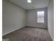 Simple bedroom with neutral carpeting and a window offering natural light at 2268 Nicole Dr, Hampton, GA 30228
