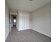 Comfortable bedroom featuring neutral carpeting and a spacious closet with double doors at 2268 Nicole Dr, Hampton, GA 30228
