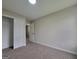 This bedroom has neutral paint, carpet and a large double door closet for storage at 2268 Nicole Dr, Hampton, GA 30228