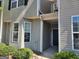 Charming townhome featuring an inviting covered entrance with natural light and manicured landscaping at 2268 Nicole Dr, Hampton, GA 30228