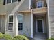 Charming townhome featuring an inviting covered entrance with natural light and manicured landscaping at 2268 Nicole Dr, Hampton, GA 30228