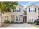 Two-story townhome featuring neutral siding, a covered front porch, and well-maintained landscaping at 2268 Nicole Dr, Hampton, GA 30228