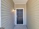 Inviting front door with sidelight and modern hardware, nestled in a cozy and well-lit entryway at 2268 Nicole Dr, Hampton, GA 30228