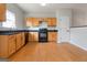 Bright kitchen features wood cabinets, laminate floors, black countertops and black appliances at 2268 Nicole Dr, Hampton, GA 30228