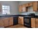 Well-lit kitchen featuring wooden cabinets, black countertops, and black appliances at 2268 Nicole Dr, Hampton, GA 30228
