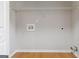 Empty laundry room with laminate floors and utility connections ready for washer and dryer at 2268 Nicole Dr, Hampton, GA 30228
