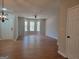 Spacious living room boasting hardwood floors, a stylish light fixture, and an abundance of natural light at 2268 Nicole Dr, Hampton, GA 30228