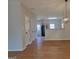 Open-concept living space featuring wood-look floors and a modern light fixture at 2268 Nicole Dr, Hampton, GA 30228