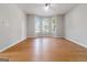 Inviting living room featuring hardwood floors, a ceiling fan, and large windows with a scenic view at 2268 Nicole Dr, Hampton, GA 30228