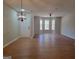 Spacious living room boasts hardwood floors, a stylish light fixture, and an abundance of natural light at 2268 Nicole Dr, Hampton, GA 30228