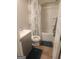 Bathroom with a shower-tub combo, a vanity with a gray cabinet, and tile flooring at 1049 Homer Ln, Stockbridge, GA 30281