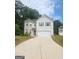 Charming two-story home with a two-car garage, light brick accents, and a well-manicured lawn at 1049 Homer Ln, Stockbridge, GA 30281