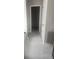 Hallway featuring modern tile flooring leading to a walk-in closet at 1049 Homer Ln, Stockbridge, GA 30281