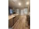 Open concept kitchen featuring stainless steel appliances, a large island, and wood floors at 1049 Homer Ln, Stockbridge, GA 30281